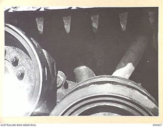 TOROKINA AREA, BOUGAINVILLE. 1945-07-28. THE REAR SUSPENSION ARM OF AN M24 GENERAL CHAFFEE LIGHT TANK IN A CLEAN CONDITION PRIOR TO TESTS CONDUCTED FOR THE WAR OFFICE