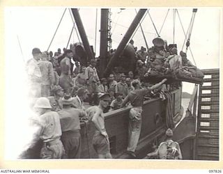 KAHILI, BOUGAINVILLE. 1945-10-02. SICK JAPANESE TROOPS, BEING EVACUATED FROM THE BUIN AREA FOR INTERNMENT ON FAURO ISLAND, BOARDING THE NEENA, A 300-TON FREIGHTER. THEY WERE WINCHED ABOARD FROM AN ..