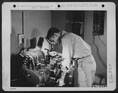 A "GI" of the 27th Air Depot Group polishes a Gimbal ring pivot from a flight indicator at the instrument shop, Port Moresby Air Depot, Papua, New Guinea. 1943. (U.S. Air Force Number 67684AC)