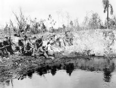 [Marines at Water Filled Bomb Crater]