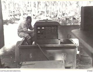 MILILAT, NEW GUINEA. 1944-09-15. T/4. H. MILLER, UNITED STATES ARMY GENERAL HEADQUARTERS ATTACHED TO 5TH DIVISION OPERATING A MOBILE ELECTRICAL GENERATOR WHICH SUPPLIES THE POWER FOR THE UNIT RADIO ..