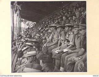 HERBERTON RACECOURSE, WONDECLA, ATHERTON TABLELAND, QLD. 1945-01-19. SPECTATORS WATCHING EVENTS FROM THE STANDS AT HQ 9 DIVISION DURING THE 9 DIVISION GYMKHANA