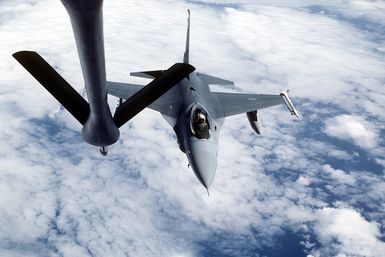 Top view of an F-16 Fighting Falcon aircraft, from the 428th Tactical Fighter Squadron, approaching the refueling boom of a KC-135 Stratotanker aircraft, to be refueled while en route to Hawaii to participate in Exercise Cope Elite