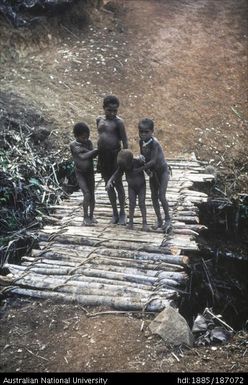 Native children standing on a bridge