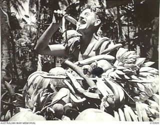 1943-10-02. NEW GUINEA. MARKHAM VALLEY. OLD MUNUM. PTE. JACK WEST OF PAGEWOOD, N.S.W. IS THE CHAMPION FRUIT COLLECTOR OF HIS BATTALION. (NEGATIVE BY MILITARY HISTORY NEGATIVES)