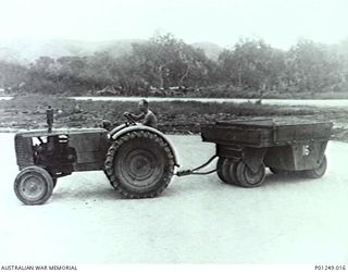 WARDS STRIP, PORT MORESBY, NEW GUINEA, 1943-03. A MEMBER OF THE RAAF DRIVES A TRACTOR TOWING A ROAD ROLLER. WARDS AERODROME WAS WORKED ON BY BOTH NO. 2 AND NO. 5 MOBILE WORKS SQUADRON (LATER ..