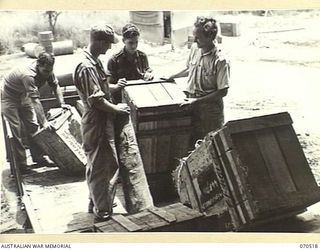 WARD'S DROME, PORT MORESBY, PAPUA, 1944-02. AUSTRALIAN AND AMERICAN SERVICEMEN UNLOADING A TRUCK AT WARD'S DROME