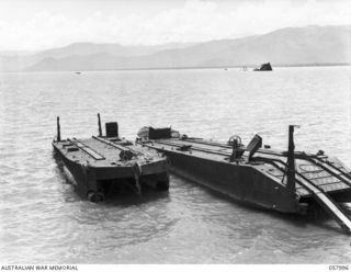 LAE, NEW GUINEA. 1943-10-12. CAPTURED JAPANESE BARGES RUSTING IN THE HARBOUR