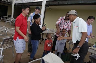 Barack Obama greets military personnel before playing golf in Kaneohe Bay, Hawaii, December 24, 2014