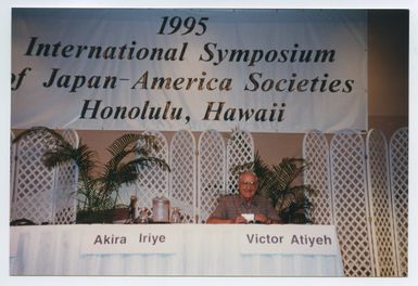 Atiyeh sitting at the table for the Symposium of Japan and America