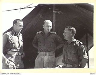 BORAM BEACH, WEWAK AREA, NEW GUINEA. 1945-08-30. CAPTAIN A.G. CORDUKES (1), MAJOR R.M. MCLEOD, BM (2), CAPTAIN E.A. BEATTIE, IO (3), MEMBERS OF HEADQUARTERS 8 INFANTRY BRIGADE