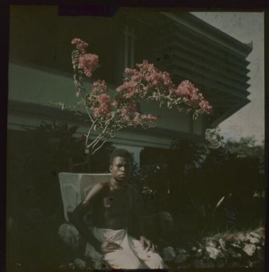 Man seated in front of the Chinnery house, Malaguna Road, Rabaul, New Guinea, ca. 1935 / Sarah Chinnery