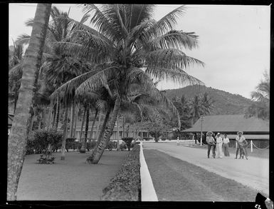 Administration buildings, Rarotonga, Cook Islands, including local men with bicycles