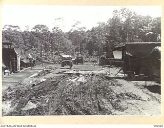 TOKO, SOUTH BOUGAINVILLE. 1945-08-30. THE MUDDY ENTRANCE TO 129 INFANTRY BRIGADE WORKSHOP