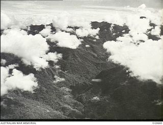 NEW GUINEA. 1944-02-27. THE FINISTERRE RANGE NORTH OF NADZAB OVER WHICH THE VULTEE VENGEANCE DIVE BOMBER AIRCRAFT OF NO. 24 SQUADRON RAAF HAD TO FLY TO ATTACK THE JAPANESE-HELD AIRSTRIP AT ..