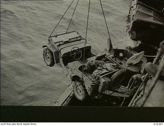 New Britain. December 1943. A Jeep is being loaded aboard a landing craft preparatory to setting out on the invasion. The immense preparation necessary for the Allied landing at Arawe emphasised ..