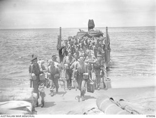 SOUTH BOUGAINVILLE. 1945-01-24. PERSONNEL OF "D" COMPANY, 9TH INFANTRY BATTALION DISEMBARKING FROM BARGES IN THE MAWARAKA AREA AS THEY PREPARE TO RELIEVE TROOPS OF "D" COMPANY, 42ND INFANTRY ..