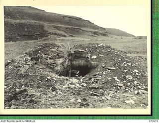 WANDOKAI, NEW GUINEA. 1944-04-18. THE EFFECTS OF TWO DIRECT HITS FIRED FROM THE 3 INCH HOWITZER OF A MATILDA TANK AT A JAPANESE TYPE COCONUT LOG BUNKER (TYPE B). MEMBERS OF THE 1ST TANK BATTALION ..