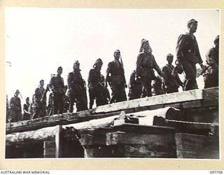 TOROKINA, BOUGAINVILLE. 1945-09-22. JAPANESE TROOPS FROM NAURU ISLAND, ON ARRIVAL AT TOROKINA PER SS RIVER BURDEKIN AND SS RIVER GLENELG, WERE MARCHED ALONG THE PIVA ROAD TO THE PRISON COMPOUND AT ..