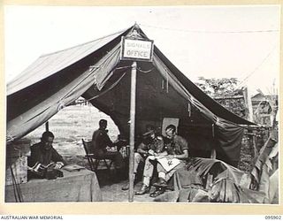 WEWAK POINT, NEW GUINEA. 1945-08-29. PERSONNEL WORKING IN THE BRIGADE SIGNALS OFFICE, 19 INFANTRY BRIGADE. IDENTIFIED PERSONNEL ARE:- SIGNALMAN N.C. BARRY (1); SIGNALMAN W.B. DOUGLAS (2); ..