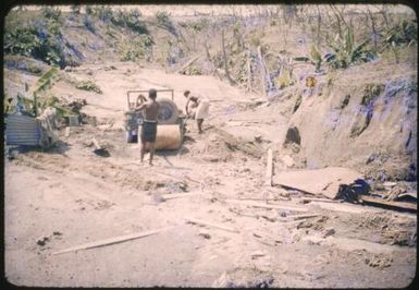 Driver digging out the medical officer's jeep, Higataru, Papua New Guinea, 1951 / Albert Speer