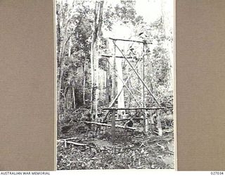 PAPUA, NEW GUINEA. 1942-10. SAPPERS OF THE 2/6TH FIELD COMPANY, ROYAL AUSTRALIAN ENGINEERS, CONSTRUCTING A STAGING FOR A "FLYING FOX" TO CARRY SUPPLIES DOWN THE STEEP GRADE FROM THE END OF THE ROAD ..