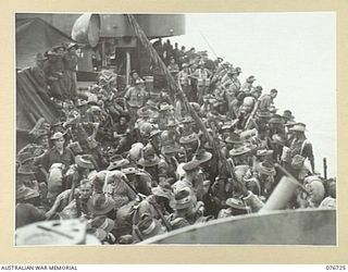 BOUGAINVILLE ISLAND, SOLOMONS. 1944-11-01. TROOPS OF THE 4TH FIELD REGIMENT LINING THE RAILS OF THE AMERICAN LIBERTY SHIP, LINDLEY M. GARRISON AWAITING TRANSPORT TO THE SHORE