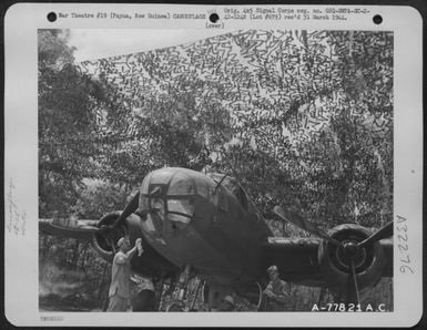 A North American B-25 Under Its Protective Covering Of Camouflage Nets Near Port Moresby, Papua, New Guinea. Nets Are Hung From Trees Around Planes. 27 November 1942. (U.S. Air Force Number A77821AC)