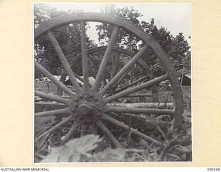 BRANDI, NEW GUINEA, 1945-09-07. A GENERAL VIEW OF 35 INFANTRY BATTALION CAMP AREA, VIEWED THROUGH THE WHEELS OF A JAPANESE TROLLEY