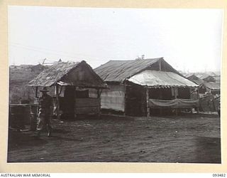 WEWAK AREA, NEW GUINEA. 1945-06-28. SHEDS AT THE FIELD MAINTENANCE CENTRE, ASSISTANT DIRECTOR OF ORDNANCE SERVICE DUMP, HEADQUARTERS 6 DIVISION. MANY OF THE SHEDS WERE CONSTRUCTED WITH THE ..