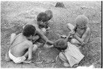 Young boys playing spear game