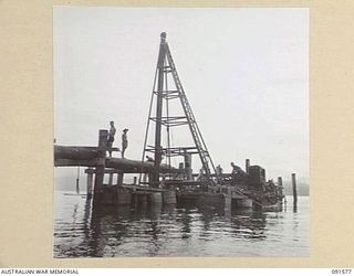 WIDE BAY, NEW BRITAIN. 1945-05-02. SAPPERS OF 13 FIELD COMPANY, ROYAL AUSTRALIAN ENGINEERS, WORKING WITH A PILE DRIVER DURING THE CONSTRUCTION OF THE NEW DOCKS