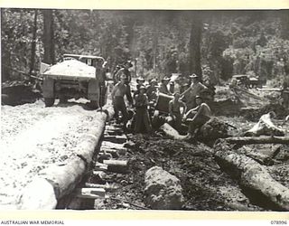 TAUT RIVER, NEW BRITAIN. 1945-02-12. TROOPS OF THE 13TH FIELD COMPANY BUILDING A NEW ROAD NEAR THE RIVER