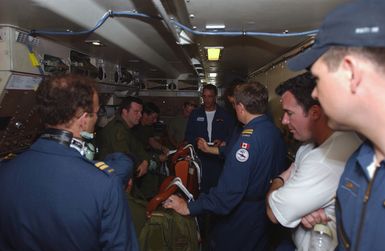 Inside the Canadian CP-140 Aurora (P-3 Orion) aircraft, 407th Maritime Patrol Squadron, the flight crew receives a mandatory emergency procedures briefing before take off from Andersen Air Force Base (AFB), Guam. The aircraft and crew are participating in the Joint exercise TANDEM THRUST 2003. The exercise is a joint endeavor including forces from the US, Canada, and Australia