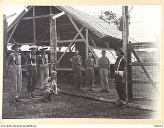 CAPE WOM, WEWAK AREA, NEW GUINEA. 1945-09-05. THREE JAPANESE PRISONERS OF WAR IN THE COMPOUND GUARDED BY 6 DIVISION PROVOST COMPANY. CATO (4), IS A JAPANESE PRISONER OF WAR ON PARADE AND HE ..