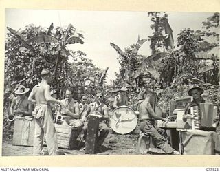 BOUGAINVILLE ISLAND. 1944-12-07. MEMBERS OF THE SWING BAND OF THE "TASMANIACS" - THE TASMANIA LINES OF COMMUNICATION CONCERT PARTY REHEARSING IN A JUNGLE CLEARING IN PREPARATION FOR THE EVENING ..