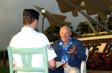 U.S. Air Force Public Affairs TECH. SGT. Mark Munsey, interviews Air Force retired Brig. GEN. Chuck Yeager, the first pilot to break the sound barrier, in front of the Hickam Missing Man Formation memorial at Hickam Air Force Base, Hawaii, on Dec. 2, 2004.(U.S. Air Force Michael Dey, CIV.) (Released)