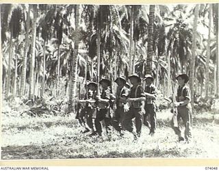 SIAR, NEW GUINEA. 1944-06-20. A PLATOON OF D COMPANY, 58/59TH INFANTRY BATTALION, "CHANGING ARMS" FROM THE "TRAIL", DURING AN EXERCISE ON THE UNIT PARADE GROUND. IDENTIFIED PERSONNEL ARE:- NX190577 ..