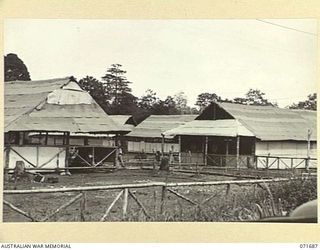 LAE, NEW GUINEA. 1944-03-25. THE 9TH AUSTRALIAN LINES OF COMMUNICATION STATIONERY DEPOT SHOWING THE ADMINISTRATION BUILDING AT THE LEFT FOREGROUND AND THE STATIONERY STORE IN THE RIGHT FOREGROUND. ..