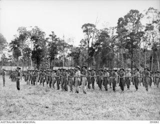 LAE AREA, NEW GUINEA, 1945-06-16. TROOPS OF 8 FIELD COMPANY, ROYAL AUSTRALIAN ENGINEERS, PRESENT ARMS FOR THE "GENERAL SALUTE" ON ARRIVAL OF LT-GEN V.A.H. STURDEE, GOC FIRST ARMY, AT A PARADE HELD ..