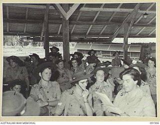 LAE, NEW GUINEA. 1945-05-07. AUSTRALIAN WOMEN'S ARMY SERVICE PERSONNEL ASSEMBLED AT THEIR NEW BARRACKS ON BUTIBUM ROAD TO HEAR THEIR HUT NUMBERS READ OUT BY CAPTAIN M.W. HORNSBY. A GROUP OF 342 ..