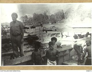 TERAPO, NEW GUINEA, 1943-09-16. NATIVES LOADING AUSTRALIAN LANDING CRAFT VEHICLES DIRECT FROM THE AUSTRALIAN ARMY SERVICE CORPS STORE SHED