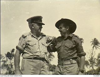 NEW GUINEA. C. 1945. FLYING OFFICER (FO) STAN SMITH, BRISBANE, QLD, WHO HAD AN UNEXPECTED MEETING WITH HIS SON, PRIVATE COLIN SMITH, AMF. THE FATHER, FO SMITH, HAS BEEN IN THE RAAF FOR TWO AND A ..