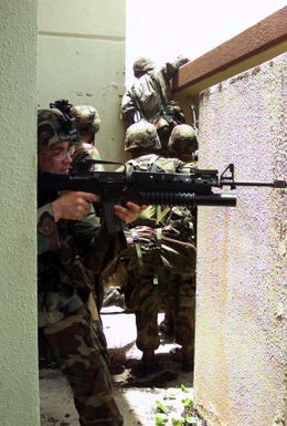 Armed with M16A2 service rifles, Marines from 31st Marine Expeditionary Unit (MEU), 2nd Battalion, 4th Marines, Fox Company, 3rd Platoon conduct Military Operations in Urban Terrain (MOUT) at an abandoned housing unit on Anderson Air Force Base (AFB), Guam in support of Exercise TANDEM THRUST 2003