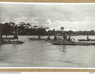 MIRAVASI, NEW GUINEA, 1943-09-07. ENGINEERS OF THE 2/4TH AUSTRALIAN FIELD SQUADRON, ROYAL AUSTRALIAN ENGINEERS THREW SEVERAL PLUGS OF GELIGNITE INTO THE LAKEKAMU RIVER. PHOTOGRAPHS SHOWS NATIVES ..