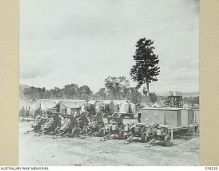 LAE, NEW GUINEA. 1944-09-27. A LINE-UP OF 2 POUNDER TANK ATTACK GUNS, SEARCHLIGHTS AND OTHER MOBILE EQUIPMENT AT THE 43RD FIELD ORDNANCE DEPOT