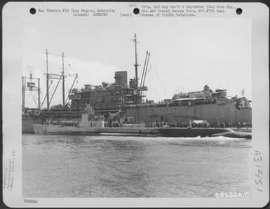 The submarine, USS Guivina, comes alongside a mother ship in Seeadler Harbor, Los Negros, Admiralty Islands, carrying the rescued flyers of the 394th Bomb Squadron, 5th Bomb Group, who were shot down while on a mission over Yap Island in the Caroline (U.S. Air Force Number 68139AC)