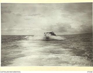 KELANOA AND BUTUBUTU, NEW GUINEA, 1944-02-08. A BARGE LOADED WITH TROOPS AND STORES OF HEADQUARTERS, 5TH DIVISION SIGNALS IN A ROUGH SEA BETWEEN KELANOA AND BUTUBUTU