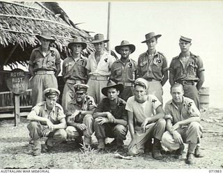 LAE, NEW GUINEA. 1944-04-01. NAVAL RATINGS AT HEADQUARTERS LAE ROYAL AUSTRALIAN NAVY PORT DIRECTORATE OUTSIDE THEIR HEADQUARTERS. IDENTIFIED PERSONNEL ARE: O/N S8760 COOK J. DUNN (1); O/N21193 ..