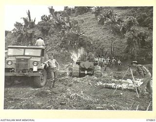 JACQUINOT BAY, NEW BRITAIN. 1944-11-07. TROOPS OF THE 12TH FIELD COMPANY, SURVEYING AND BUILDING A GRAVEL "CHINAMAN" IN A MUDDY SECTION OF THE AREA CONTROLLED BY THE 6TH INFANTRY BRIGADE. ..